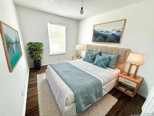 a view of a room with wooden floor and white walls