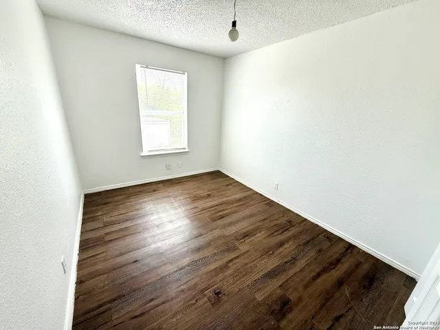a bedroom with a large bed and a flat screen tv