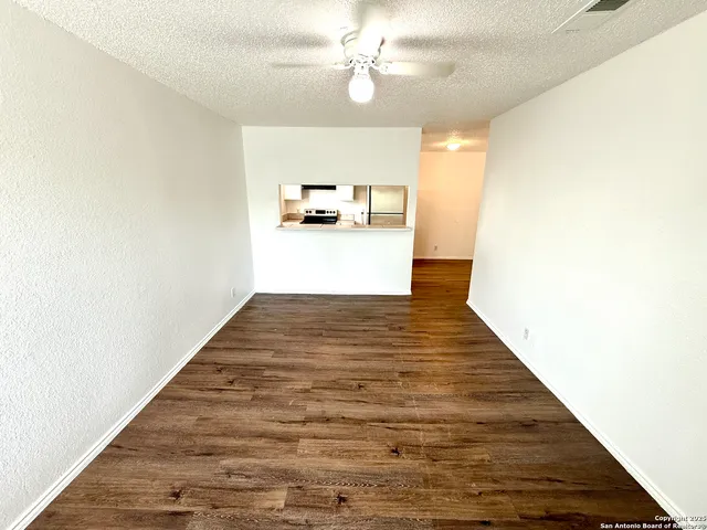 a view of kitchen and hall with wooden floor