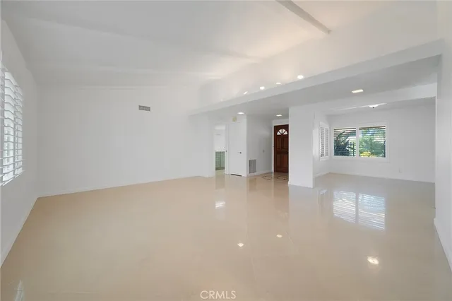 an empty room with a empty space and windows