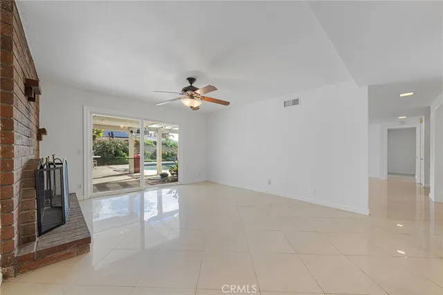 a kitchen with stainless steel appliances granite countertop a refrigerator sink stove and white cabinets