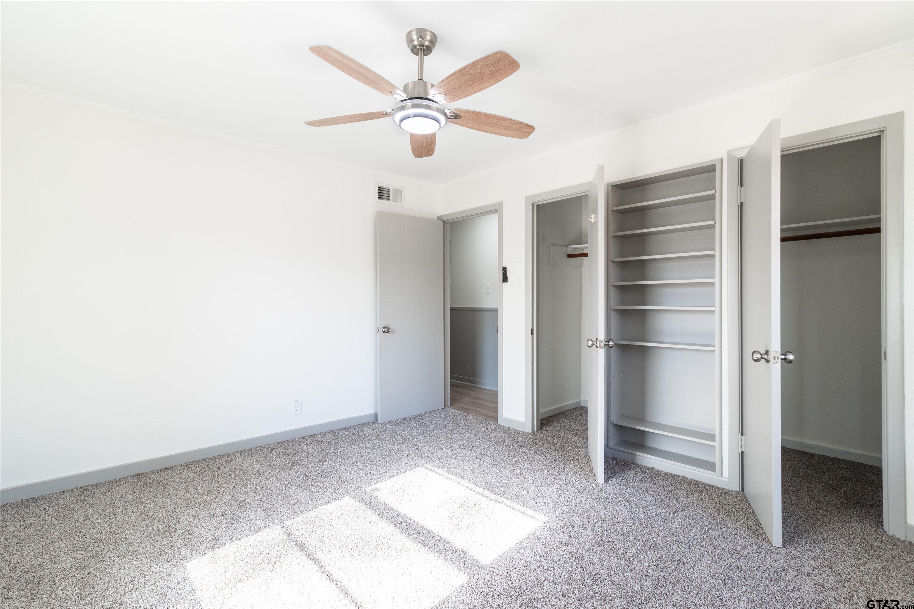 2419 Pounds Avenue Tyler, TX 75701 - Photo 25 of 48 a view of an empty room with a ceiling fan