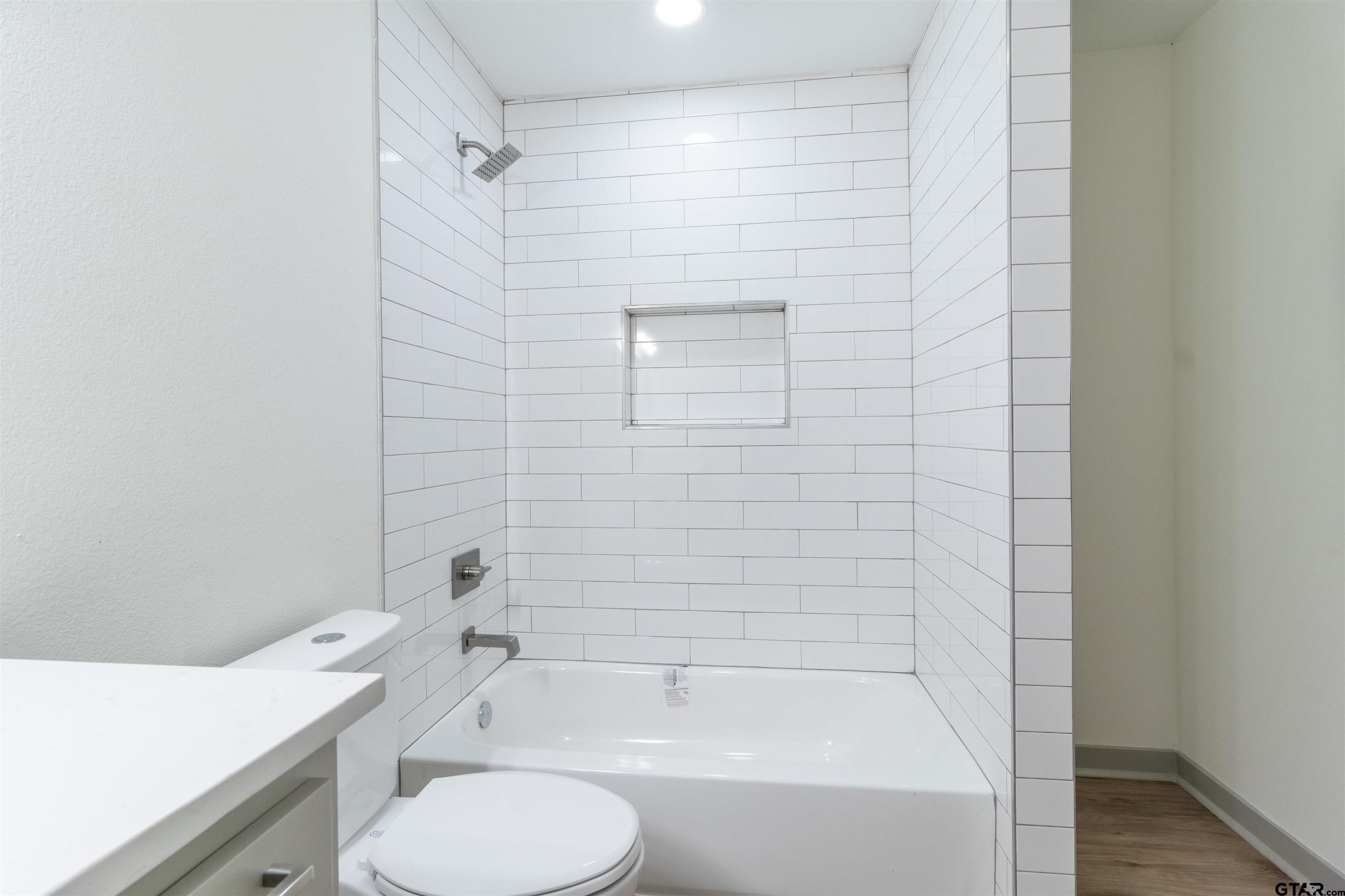 2419 Pounds Avenue Tyler, TX 75701 - Photo 30 of 48 a bathroom with a shower and a toilet