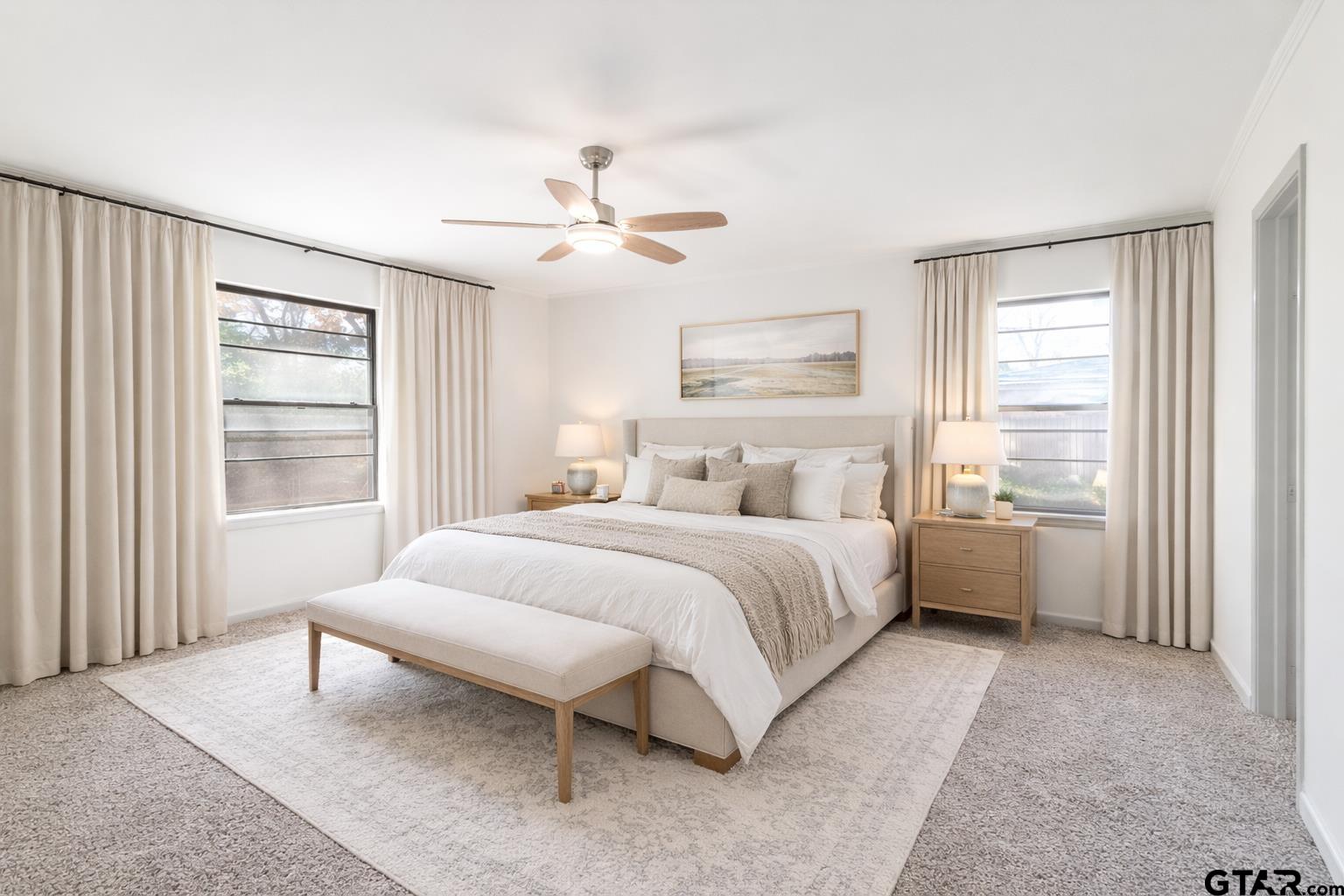 2419 Pounds Avenue Tyler, TX 75701 - Photo 32 of 48 a bedroom with a large bed and a chandelier