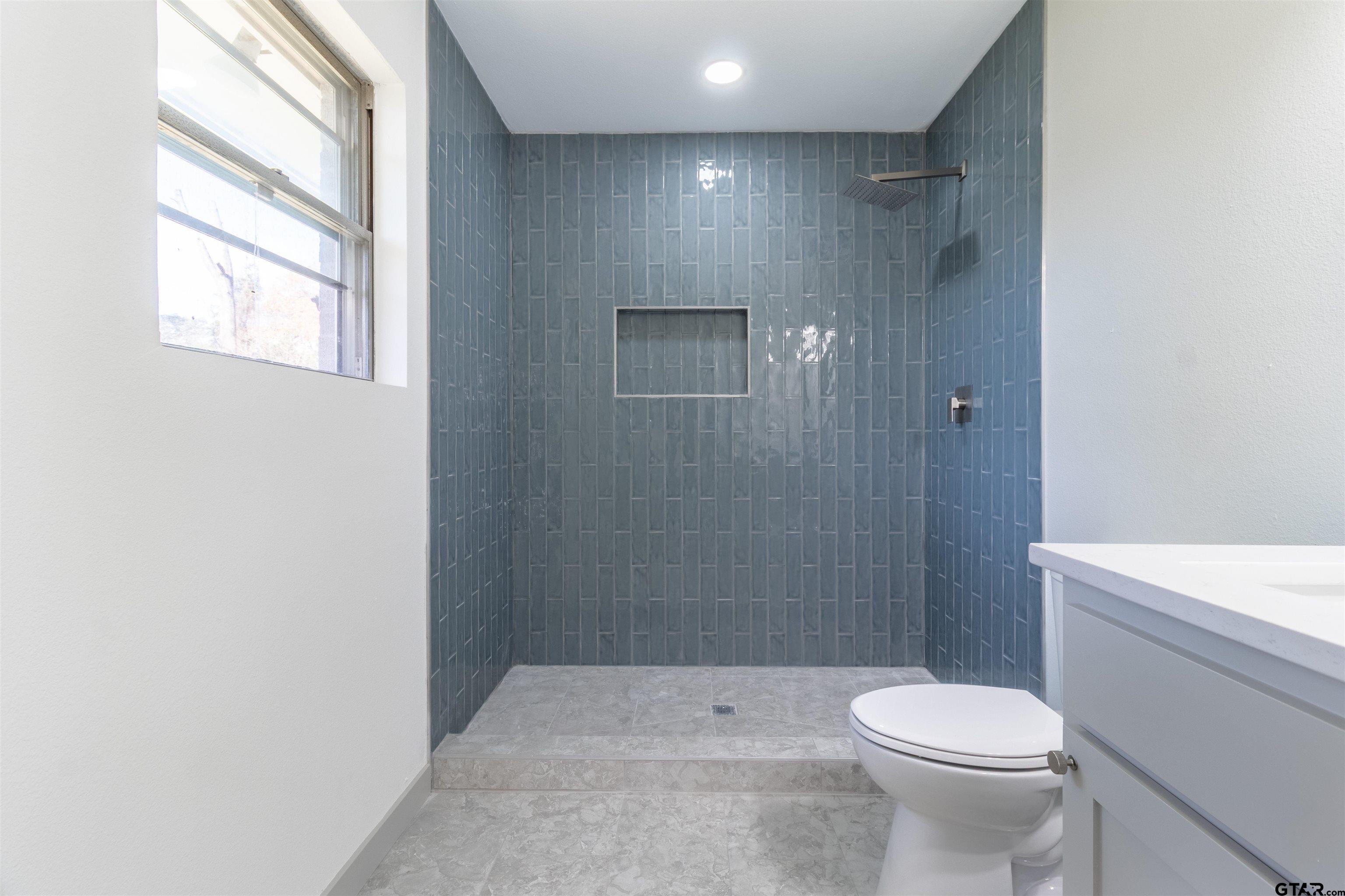 2419 Pounds Avenue Tyler, TX 75701 - Photo 35 of 48 a bathroom with a toilet a sink and shower
