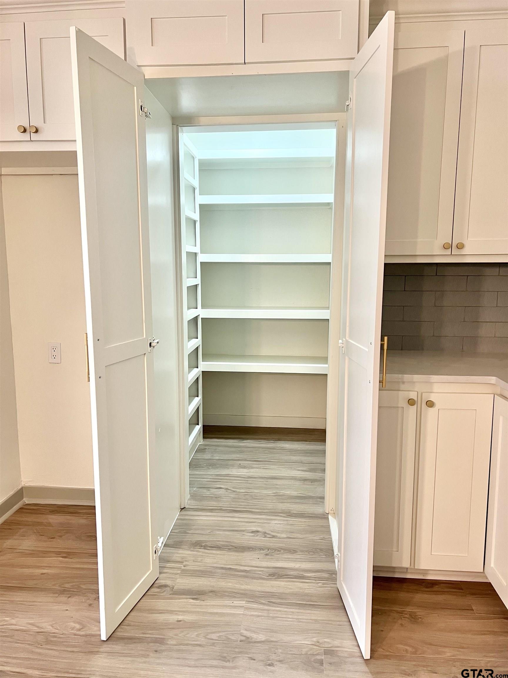 2419 Pounds Avenue Tyler, TX 75701 - Photo 48 of 48 a view of a walk in closet with wooden floor