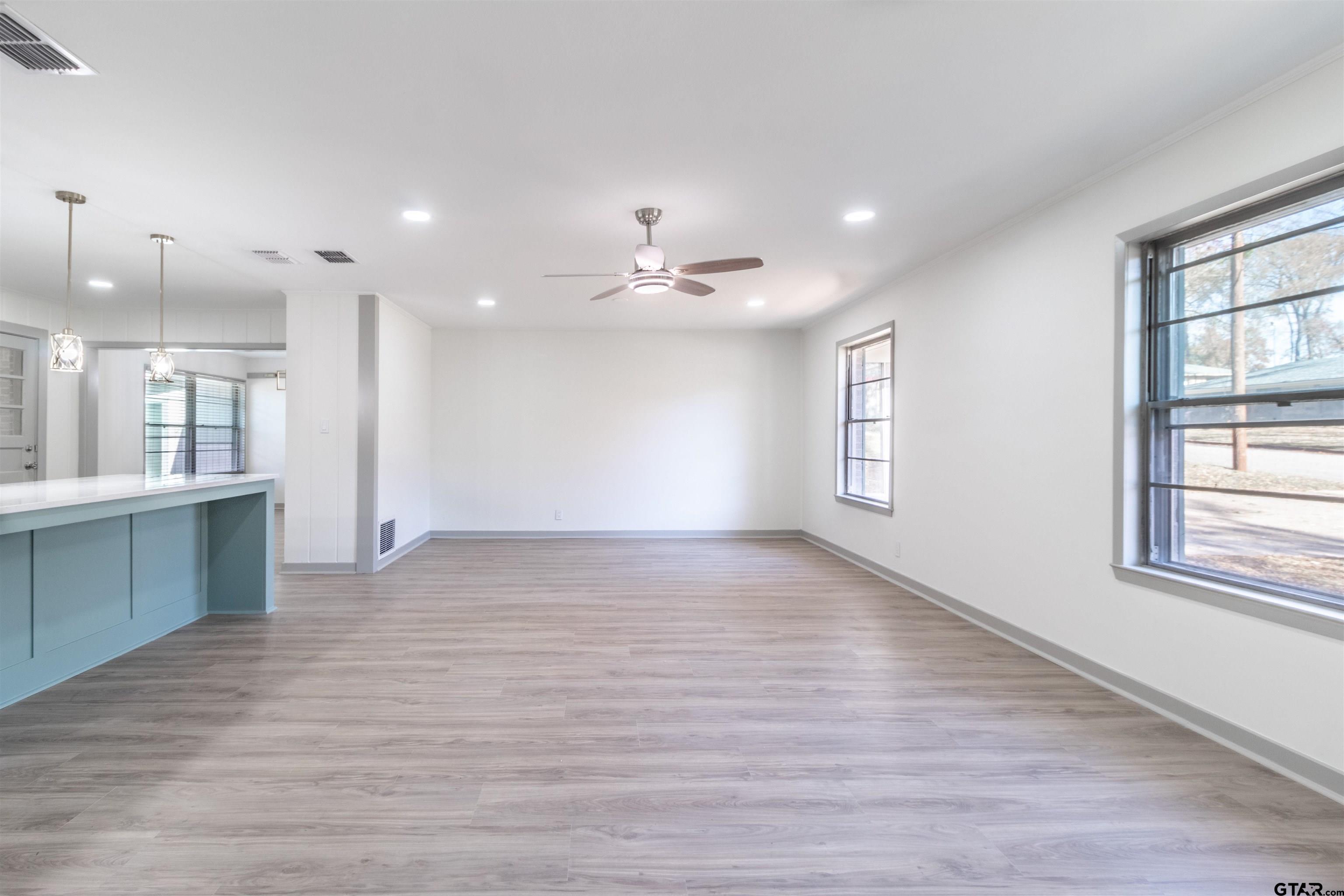 2419 Pounds Avenue Tyler, TX 75701 - Photo 9 of 48 an empty room with wooden floor and windows