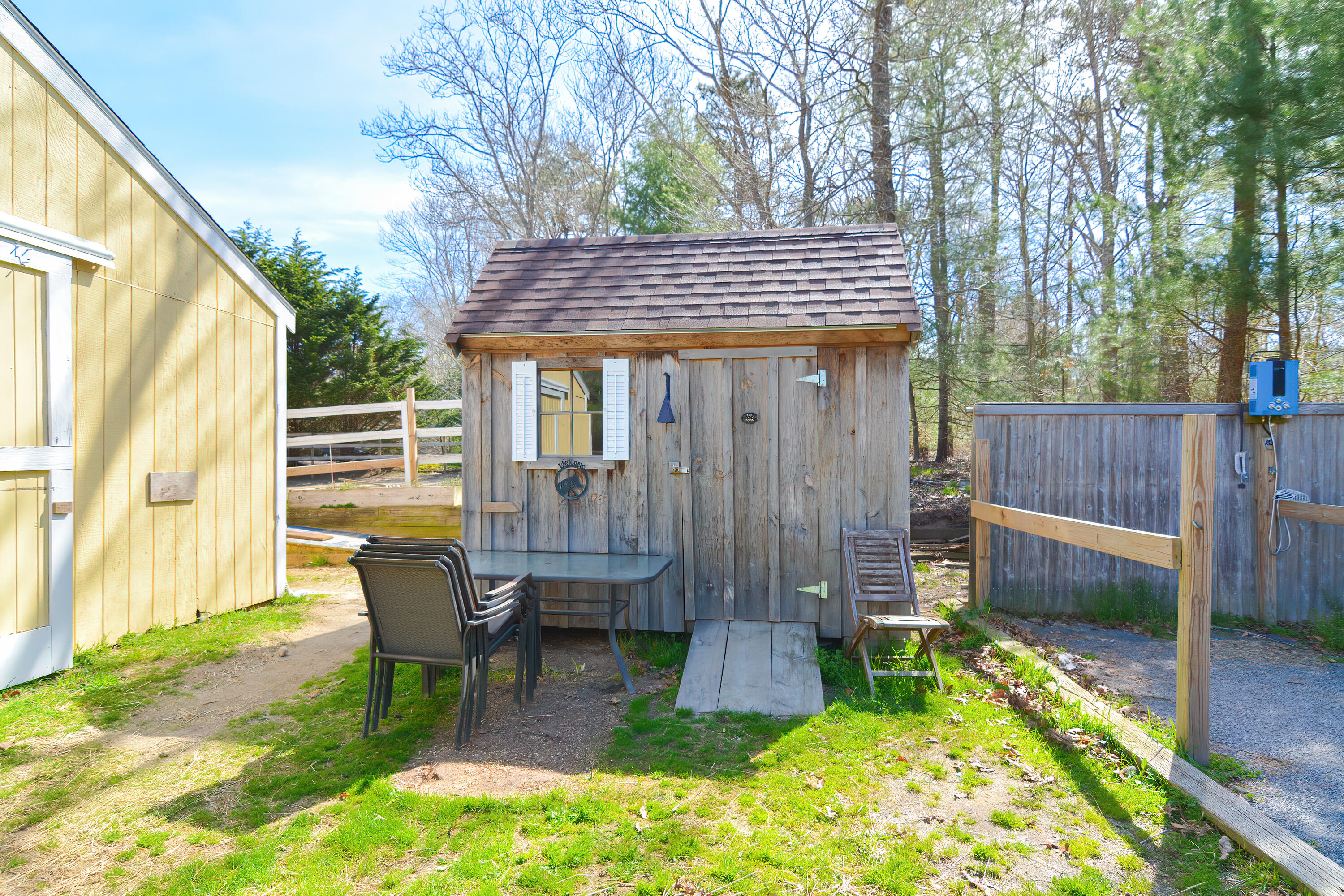 836 Cotuit Road Mashpee, MA 02649 - Photo 54 of 58 a view of a chair and table in backyard of the house