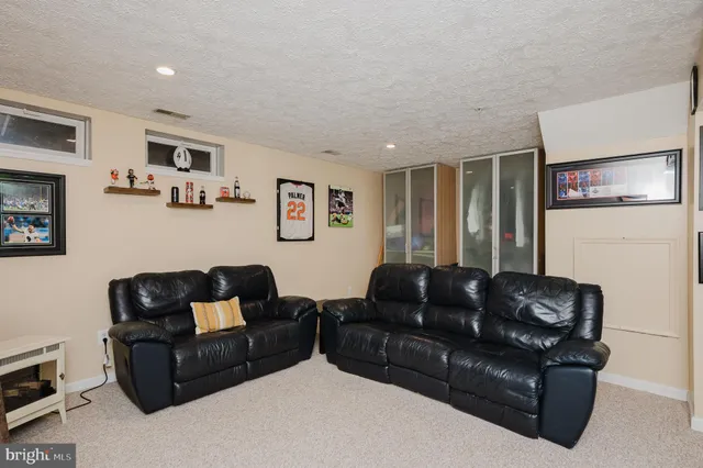 a living room with furniture cabinets and window