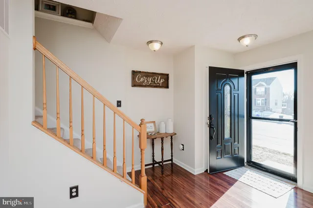 a view of entryway with wooden floor and windows
