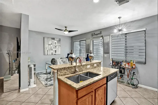 a kitchen with stainless steel appliances granite countertop a sink a stove and a refrigerator