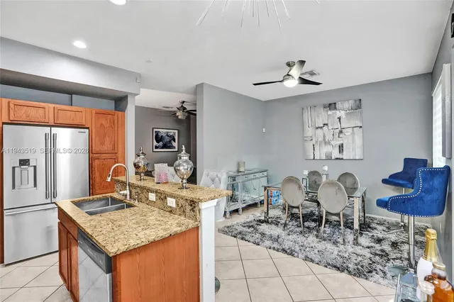 a kitchen with granite countertop cabinets and chairs