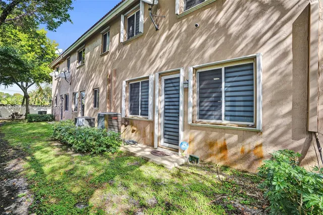 a view of a house with a yard and pathway