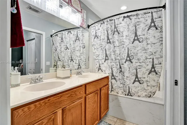 a bathroom with a granite countertop sink a mirror a shower and a shower