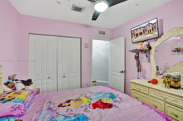 a bedroom with a bed and hallway