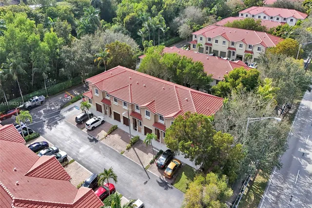 an aerial view of a house with garden space and a street view