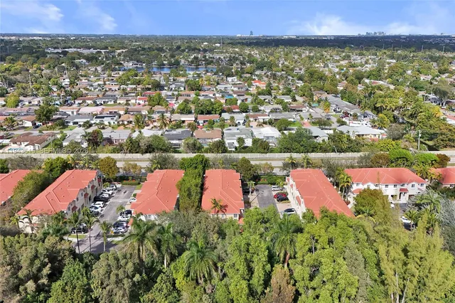 an aerial view of a houses with a yard