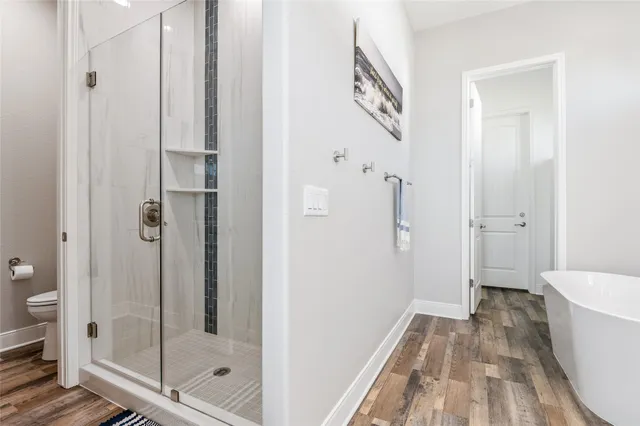 a bathroom with a bathtub and a shower