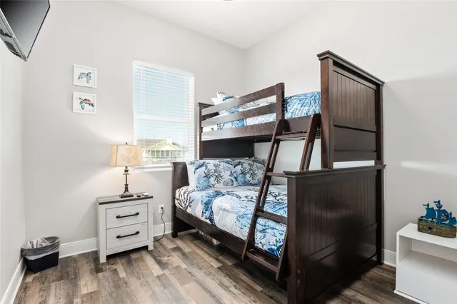 a bedroom with furniture and wooden floor