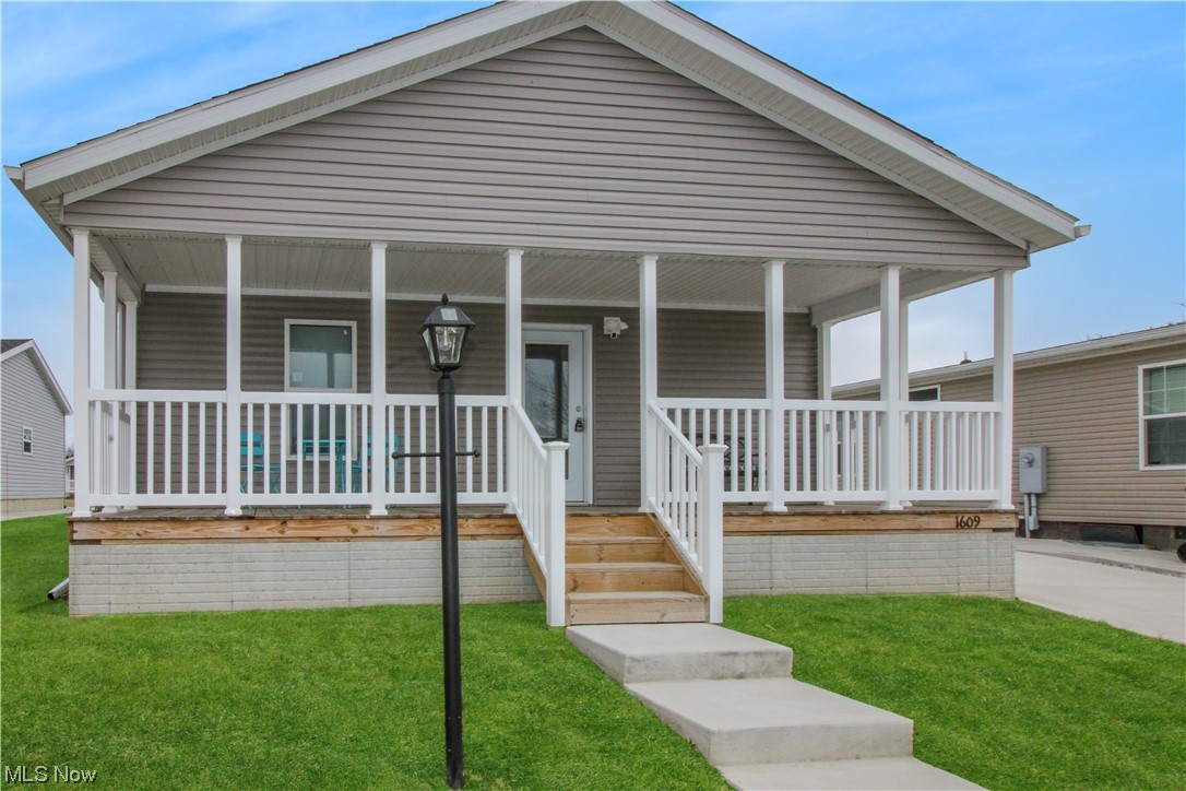 1609 Coldwater Crossing Road Lakeside Marblehead, OH 43440 - Photo 1 of 38 View of front facade with a front lawn and covered porch
