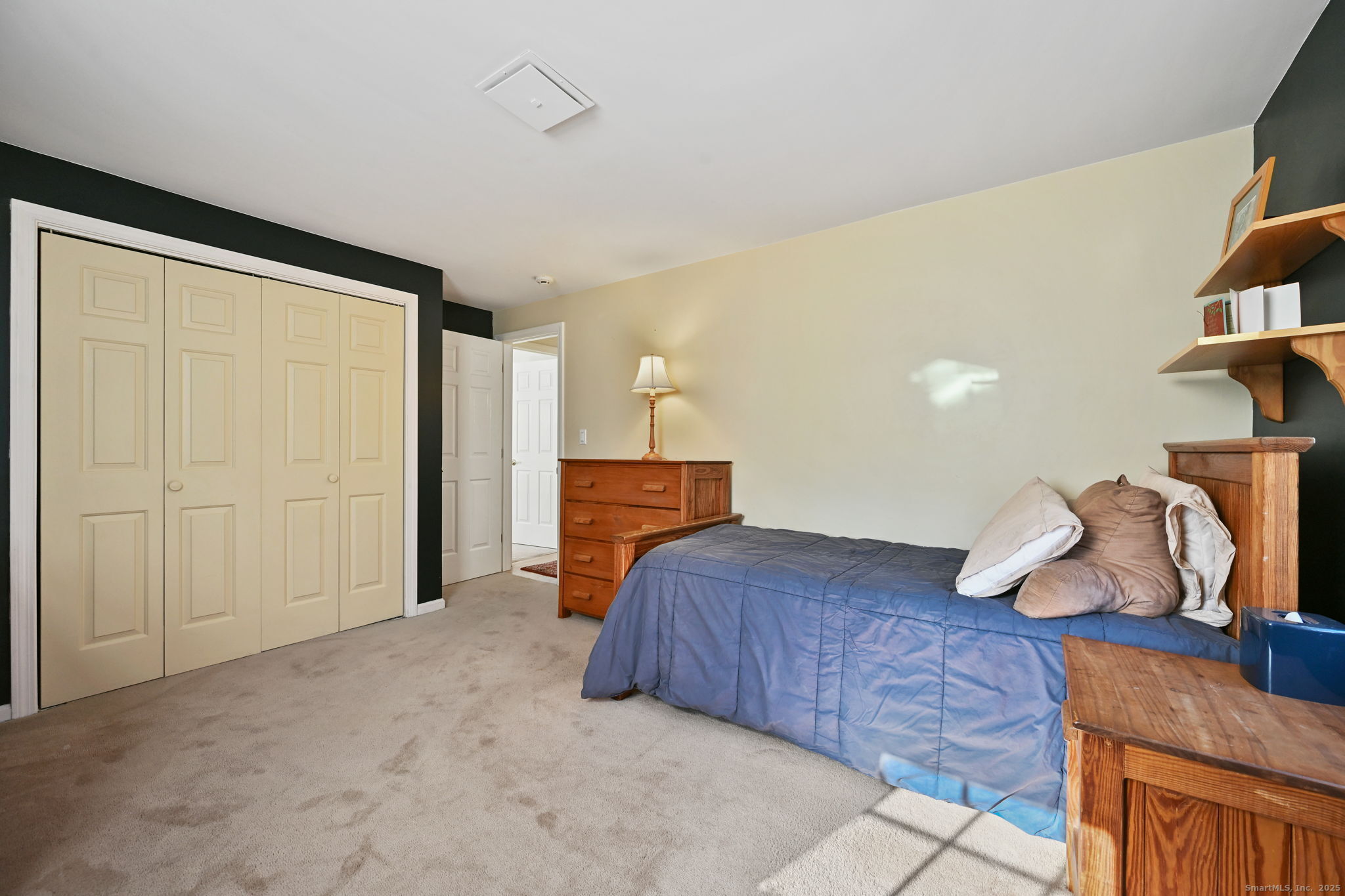 269 Thunder Lake Road Wilton, CT 06897 - Photo 18 of 26 a bedroom with a bed and cabinets