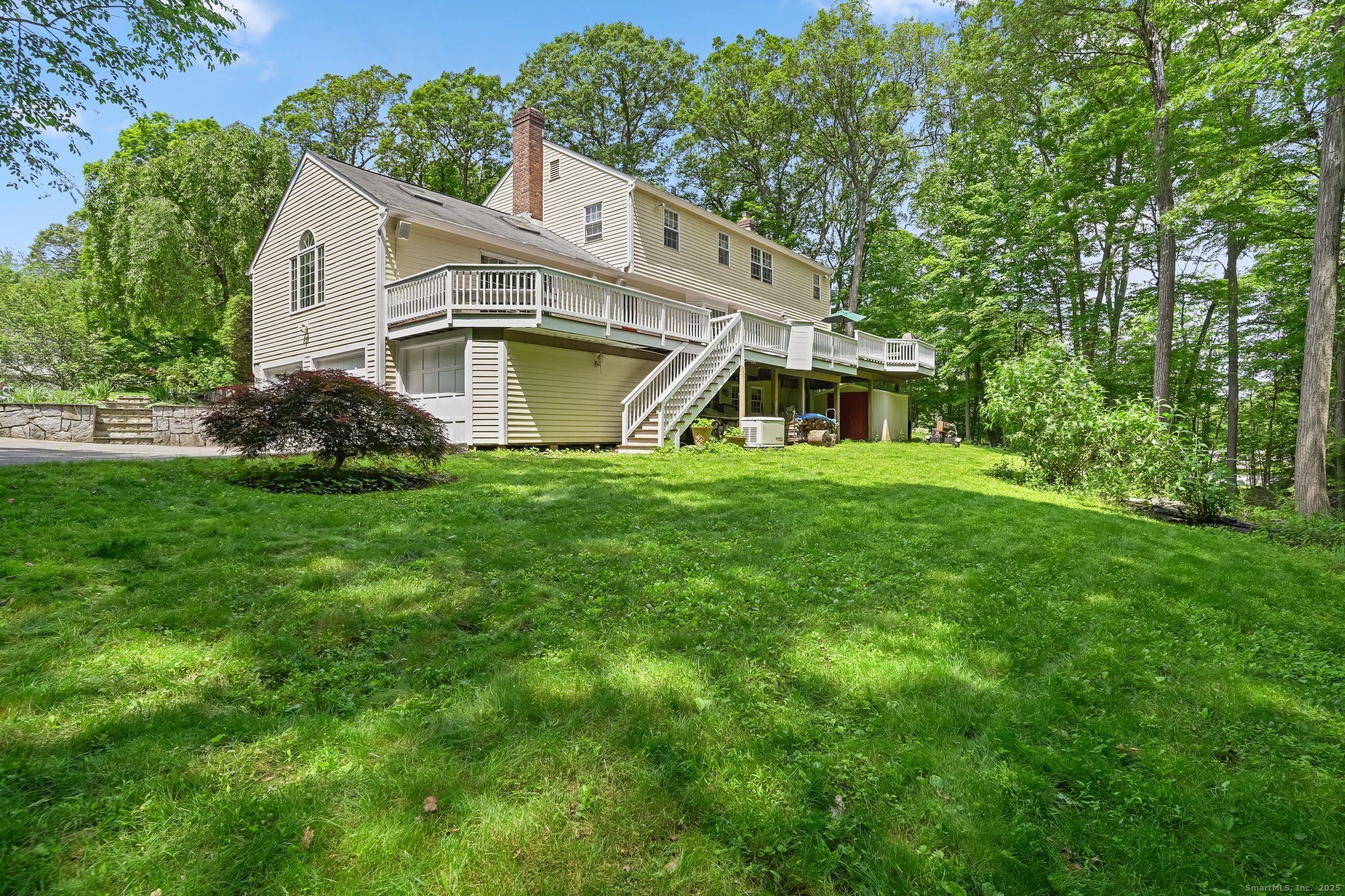 269 Thunder Lake Road Wilton, CT 06897 - Photo 21 of 26 a view of a house with a big yard and large trees