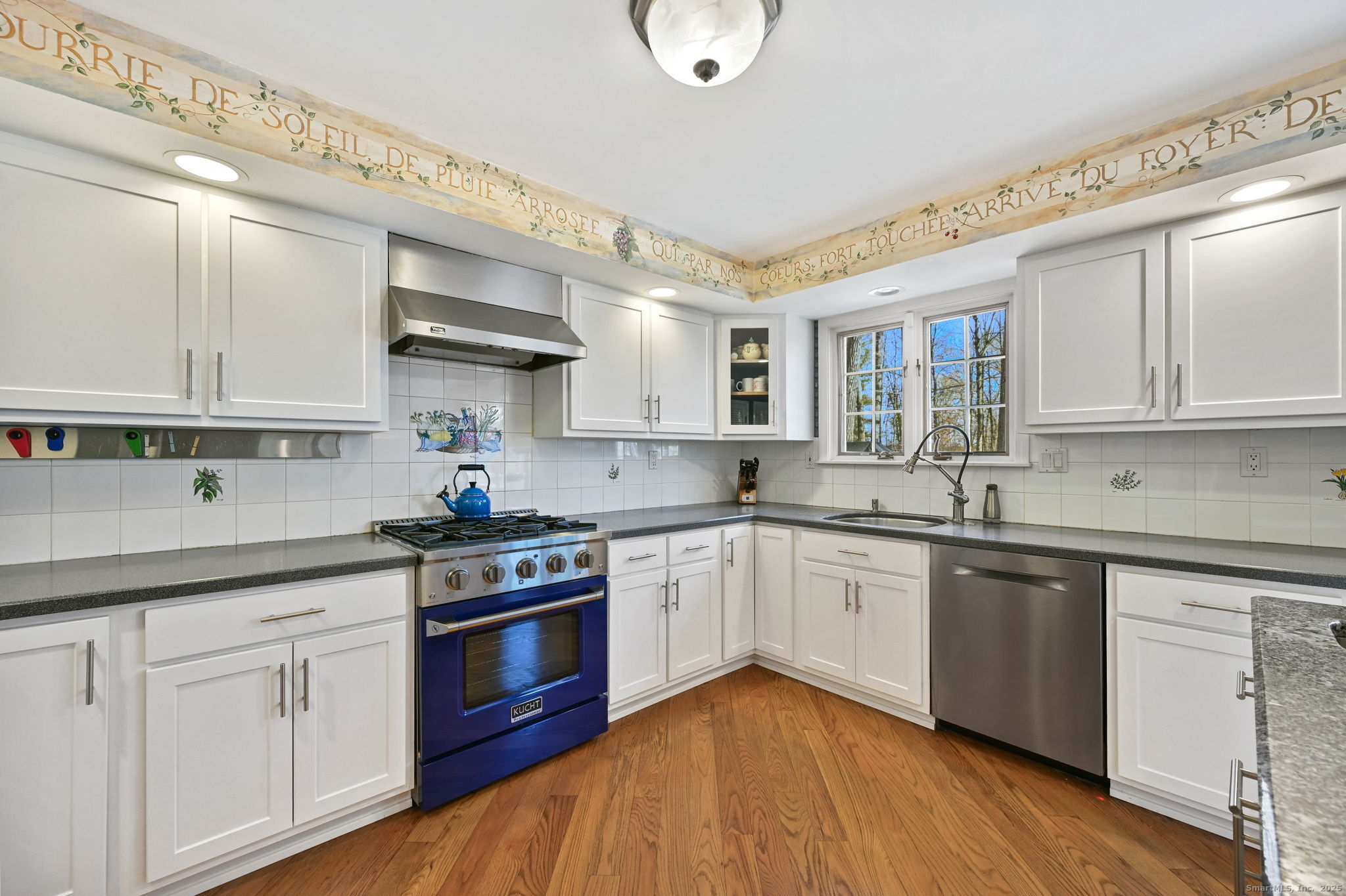 269 Thunder Lake Road Wilton, CT 06897 - Photo 9 of 26 a kitchen with stainless steel appliances granite countertop a sink cabinets and wooden floor