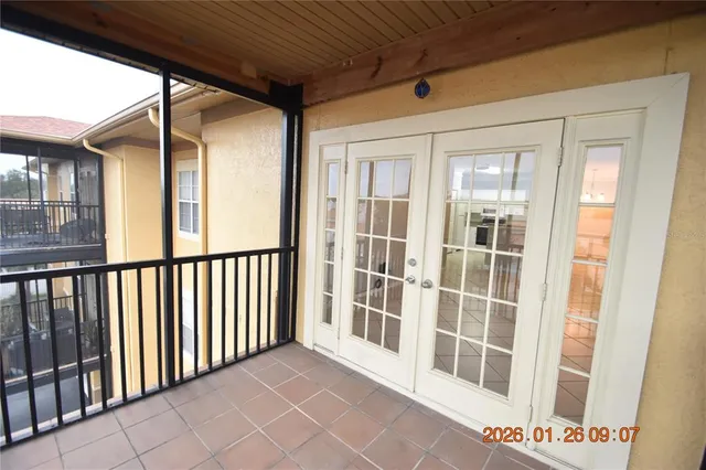 a view of a balcony with wooden floor and fence