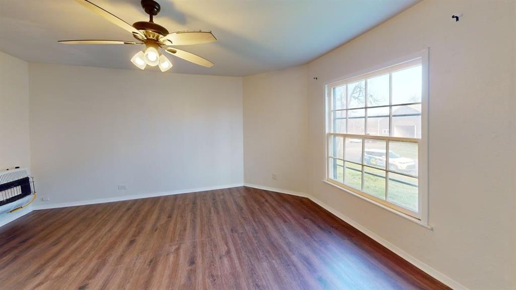 224 West Hull Street, Unit B Denison, TX 75020 - Photo 6 of 13 wooden floor in an empty room with a window