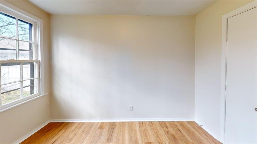 224 West Hull Street, Unit B Denison, TX 75020 - Photo 8 of 13 an empty room with wooden floor and windows
