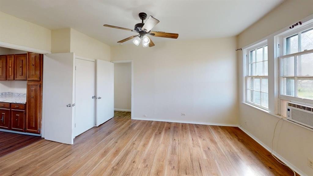 224 West Hull Street, Unit B Denison, TX 75020 - Photo 9 of 13 wooden floor in an empty room with a window