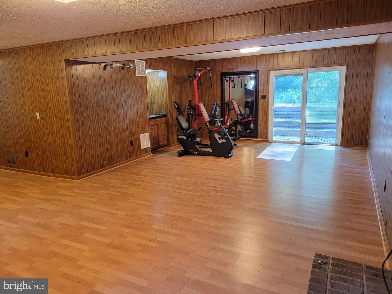 6684 Old Blacksmith Drive Burke, VA 22015 - Photo 16 of 26 a view of a room with wooden floor and furniture