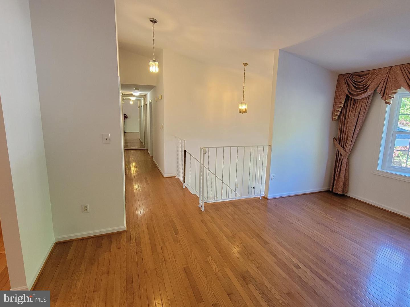 6684 Old Blacksmith Drive Burke, VA 22015 - Photo 5 of 26 a view of a hallway with wooden floor