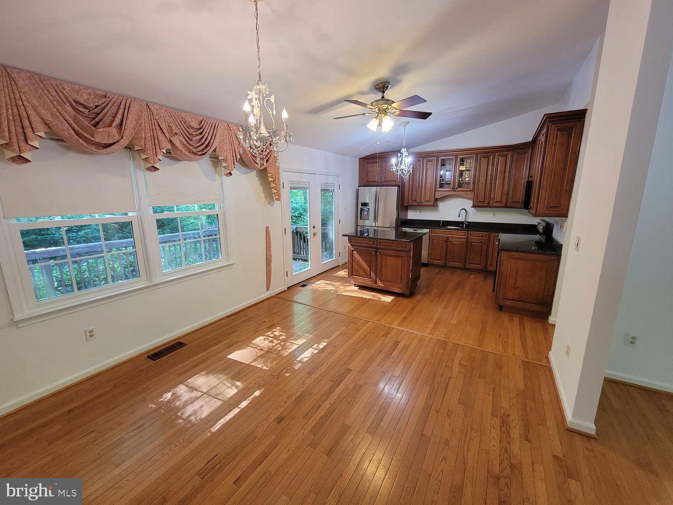 6684 Old Blacksmith Drive Burke, VA 22015 - Photo 7 of 26 a view of kitchen and dining room with wooden floor