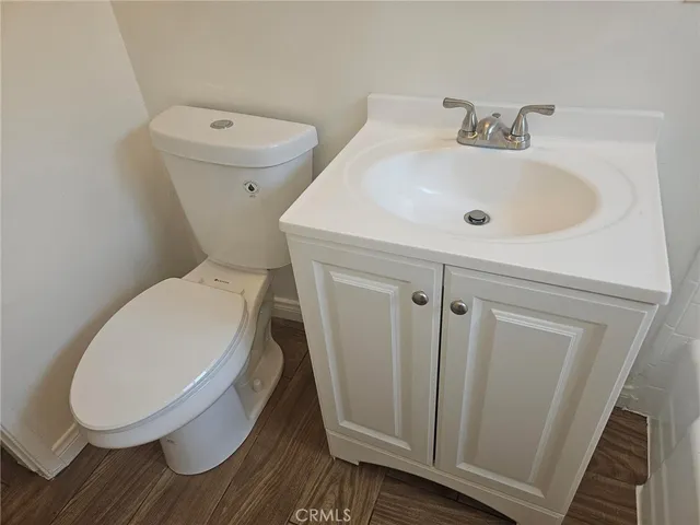 a white toilet sitting next to a bathroom sink