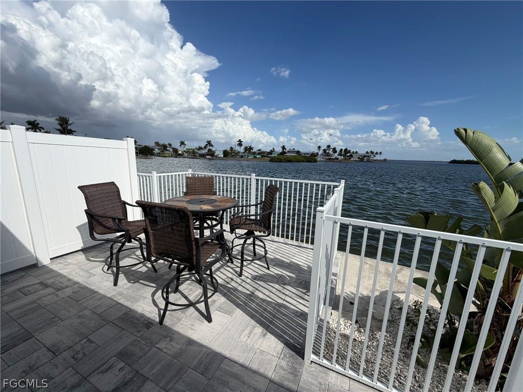 4743 Pine Island Road Matlacha, FL 33993 - Photo 11 of 34 a view of a chair and table on the terrace