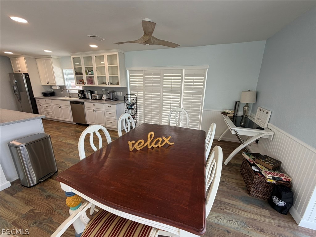 4743 Pine Island Road Matlacha, FL 33993 - Photo 14 of 34 a view of a dining room with furniture window and wooden floor