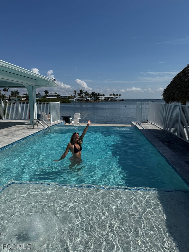 4743 Pine Island Road Matlacha, FL 33993 - Photo 2 of 34 a backyard of a house with barbeque oven table and chairs