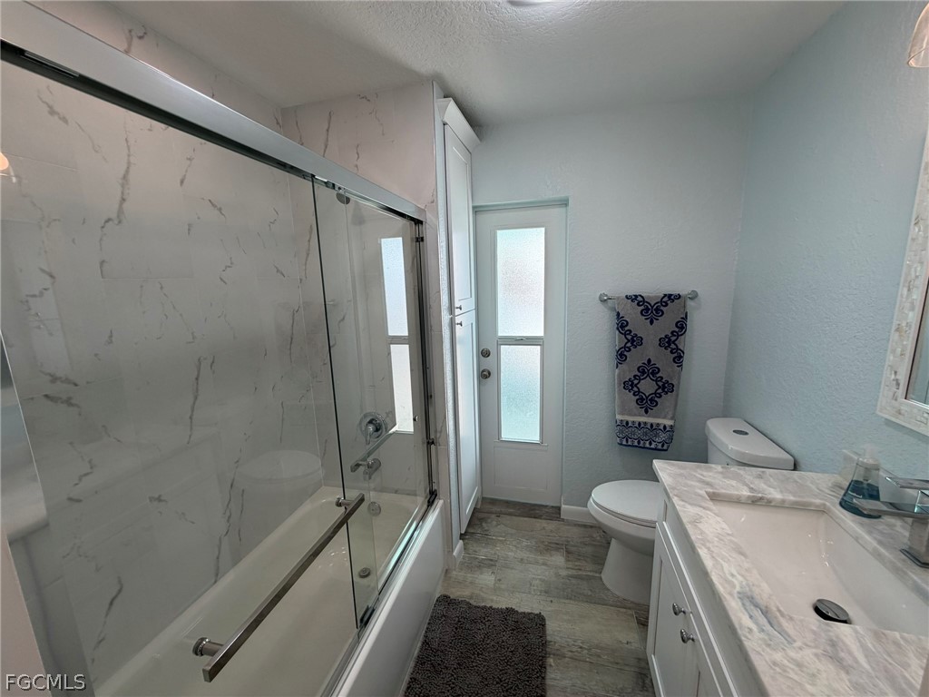 4743 Pine Island Road Matlacha, FL 33993 - Photo 22 of 34 a bathroom with a granite countertop sink toilet and shower