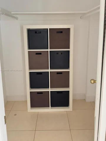a bathroom with a granite countertop bathtub shower sink vanity and toilet