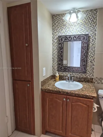 a living room with a couch and a potted plant on table