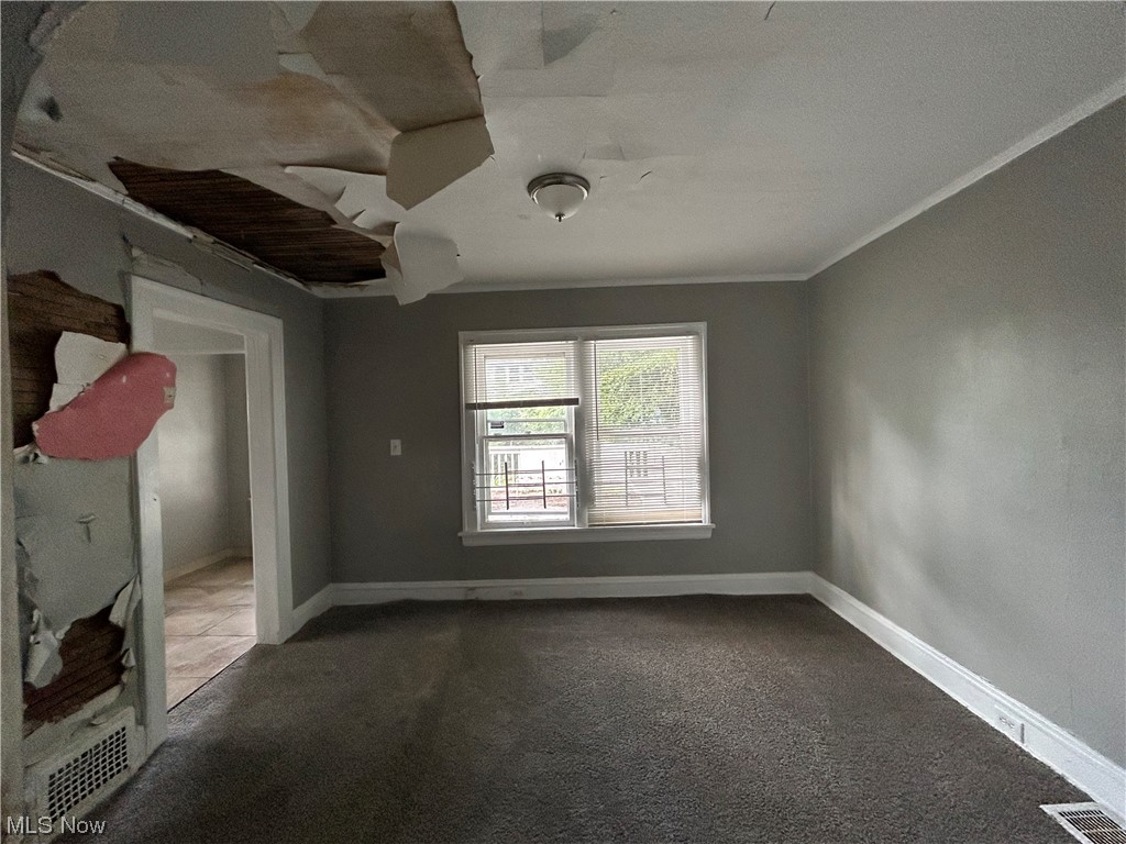 14732 Wemple Road Cleveland, OH 44110 - Photo 3 of 14 Carpeted spare room with ceiling fan