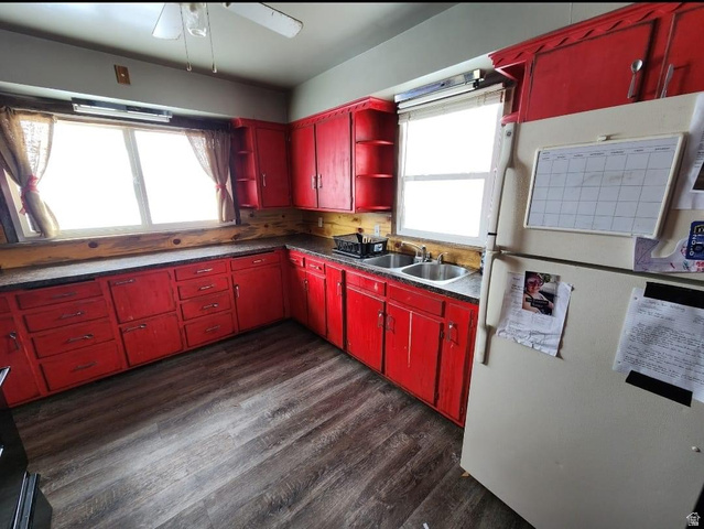 102 South Main Street Paris, ID 83261 - Photo 11 of 33 Kitchen with red cabinetry, freestanding refrigerator, dark wood-style floors, and dark countertops