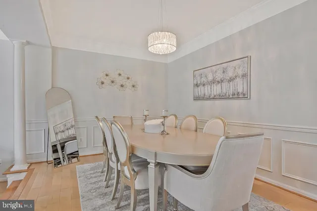 a view of a dining room with furniture and a chandelier