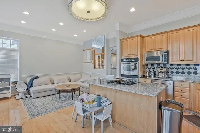 a kitchen with stainless steel appliances granite countertop a sink and cabinets