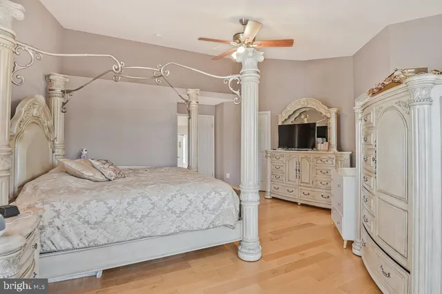 a spacious bedroom with a bed and a view of bathroom