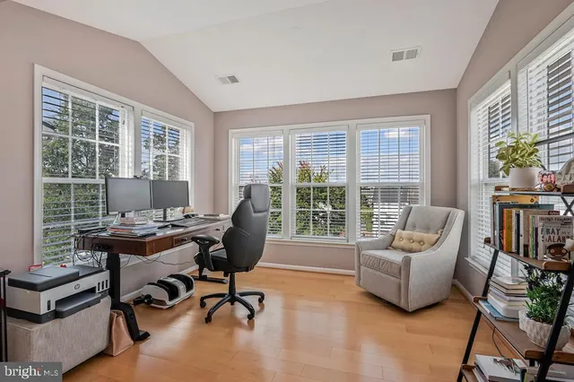 a view of a livingroom with workspace and a window