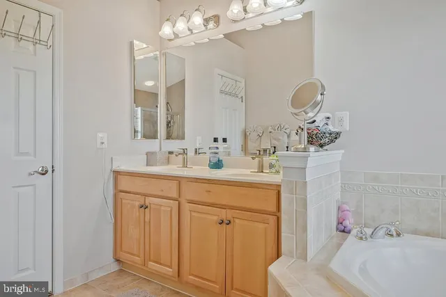 a bathroom with a sink vanity and mirror