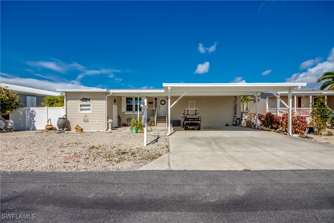 3083 Sloop Lane St. James City, FL 33956 - Photo 2 of 41 a front view of a house with a patio