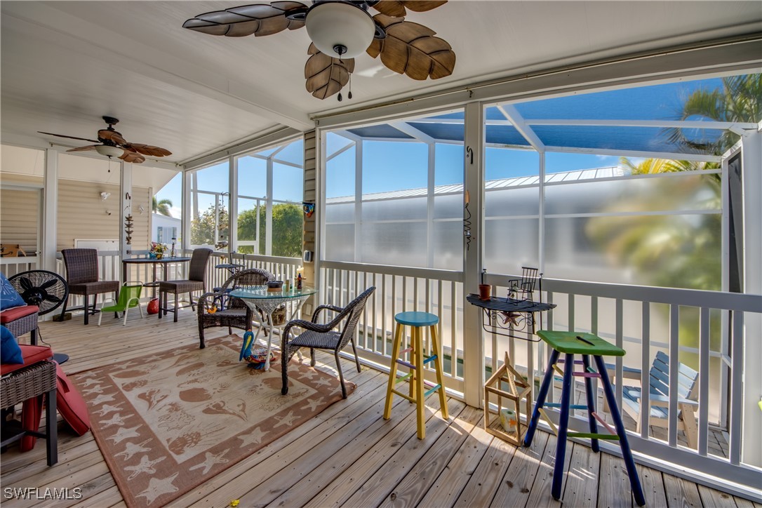 3083 Sloop Lane St. James City, FL 33956 - Photo 28 of 41 a view of a dining room and livingroom with furniture wooden floor a chandelier